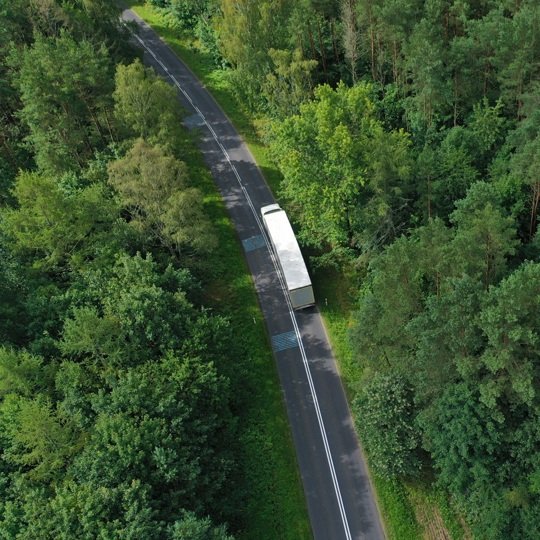 aerial drone perspective view on white truck with cargo trailer